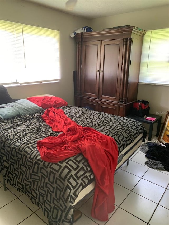 bedroom with light tile patterned floors