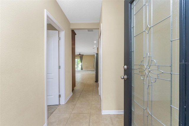 corridor featuring light tile patterned floors