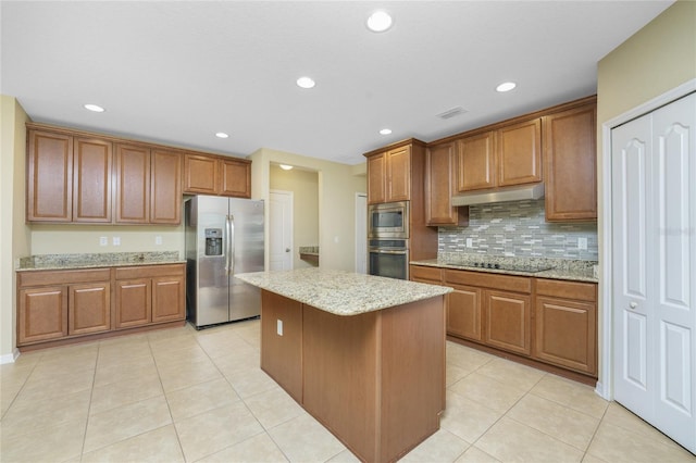 kitchen featuring appliances with stainless steel finishes, a center island, light tile patterned floors, and light stone countertops