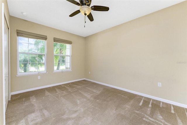 empty room with ceiling fan and carpet floors