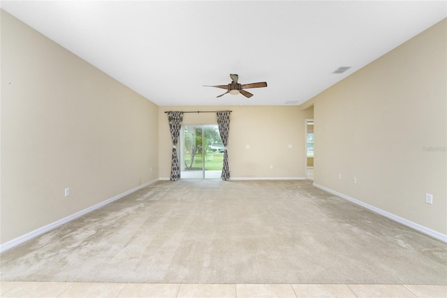 carpeted spare room featuring ceiling fan