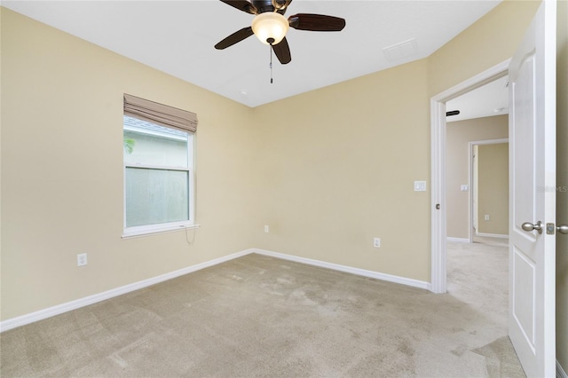 carpeted empty room featuring ceiling fan