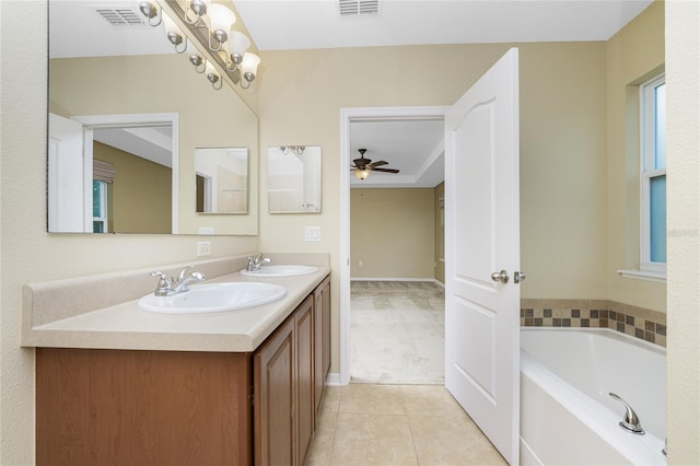 bathroom featuring ceiling fan, tile patterned flooring, a tub to relax in, and vanity