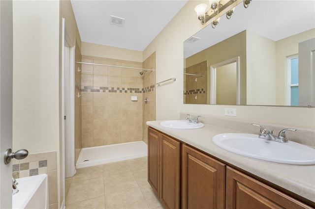 bathroom featuring plus walk in shower, tile patterned flooring, and vanity