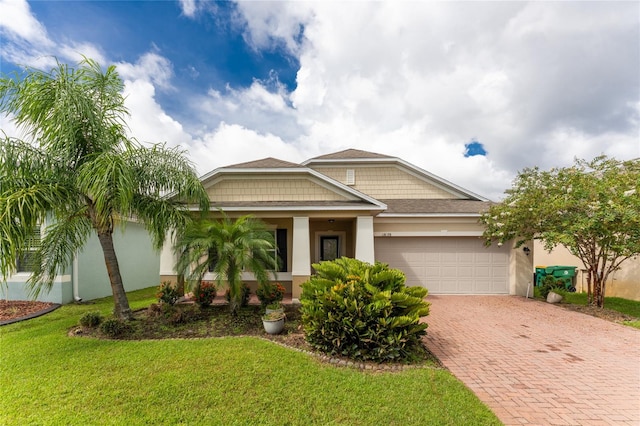 view of front of home with a garage and a front lawn