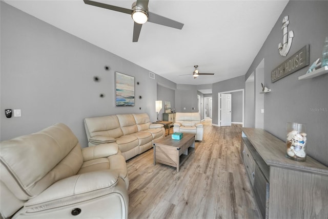 living room with ceiling fan and light hardwood / wood-style flooring