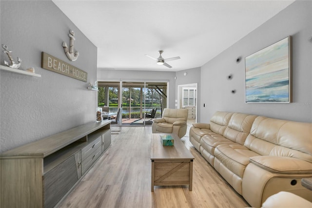 living room featuring ceiling fan and light wood-type flooring