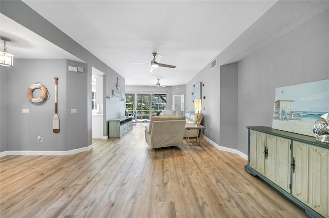 living room with ceiling fan and light wood-type flooring