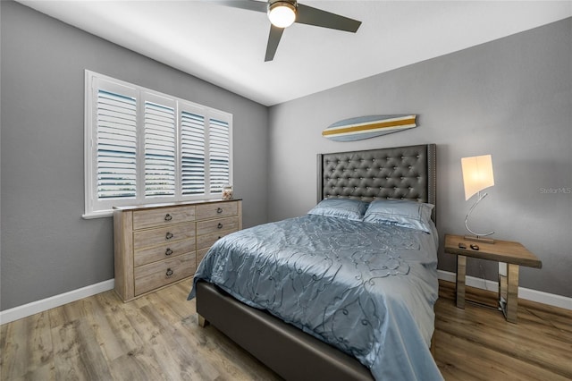 bedroom with ceiling fan and light wood-type flooring