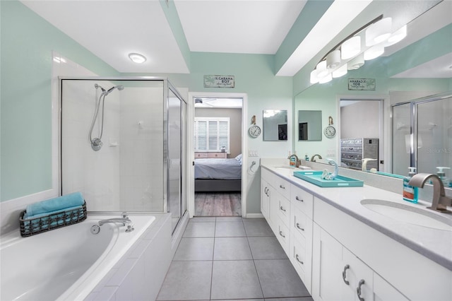 bathroom with shower with separate bathtub, tile patterned floors, and vanity