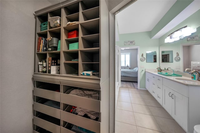 interior space with vanity and tile patterned floors