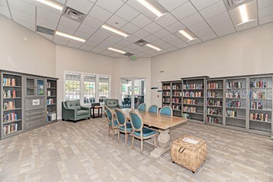 office area featuring a towering ceiling and a drop ceiling