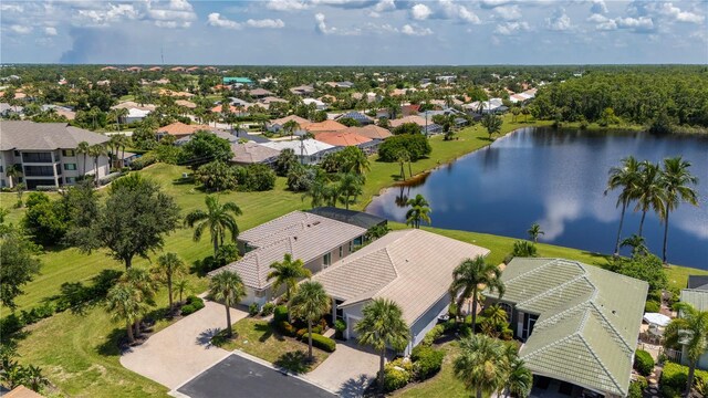 birds eye view of property with a water view and a residential view