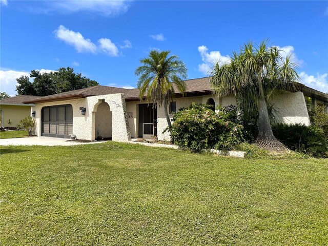 single story home featuring a front yard and a garage