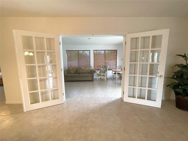 tiled spare room featuring french doors