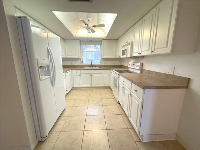 kitchen with white cabinets, white appliances, and sink