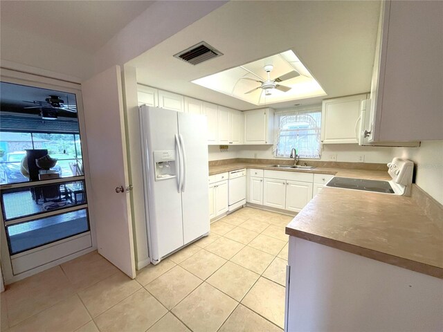 kitchen with light tile patterned floors, white appliances, white cabinetry, and sink