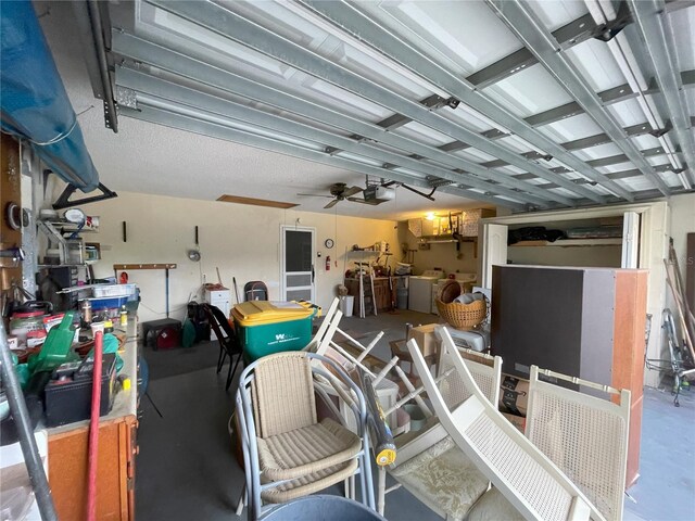 garage featuring independent washer and dryer, a garage door opener, and ceiling fan