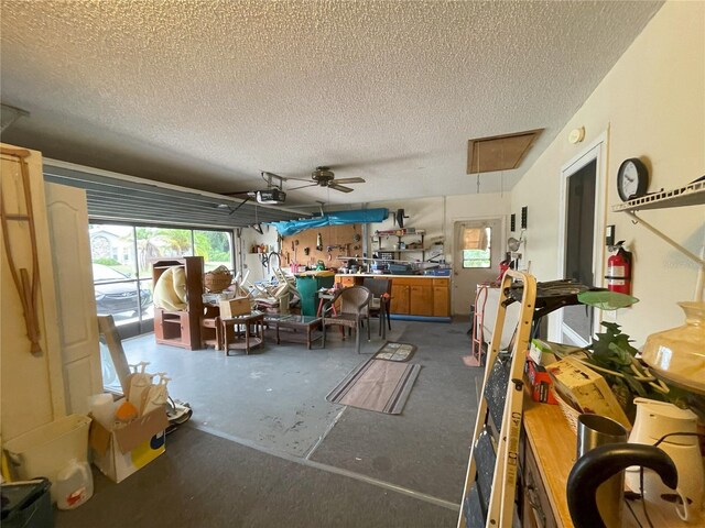 misc room with a textured ceiling, ceiling fan, and concrete floors