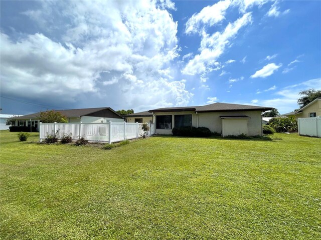 back of property featuring a yard