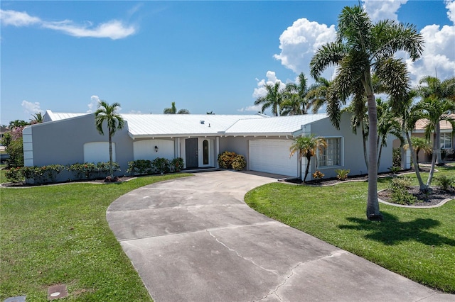 ranch-style home with a front lawn and a garage