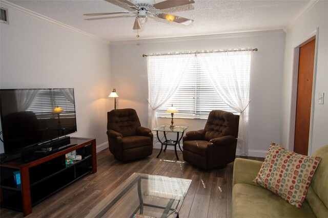 living room with dark hardwood / wood-style floors, ornamental molding, and a textured ceiling