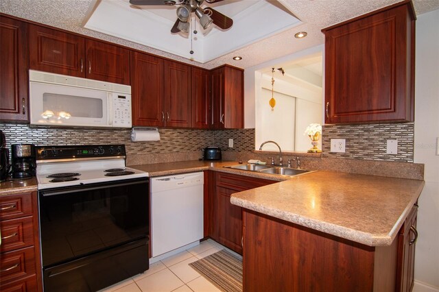 kitchen with a textured ceiling, white appliances, tasteful backsplash, and sink