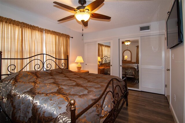 bedroom featuring a textured ceiling, ceiling fan, and dark wood-type flooring