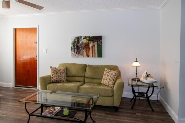 living room with ornamental molding, a textured ceiling, ceiling fan, and dark wood-type flooring