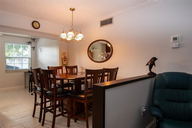 dining room with light tile patterned flooring, a chandelier, a textured ceiling, and ornamental molding