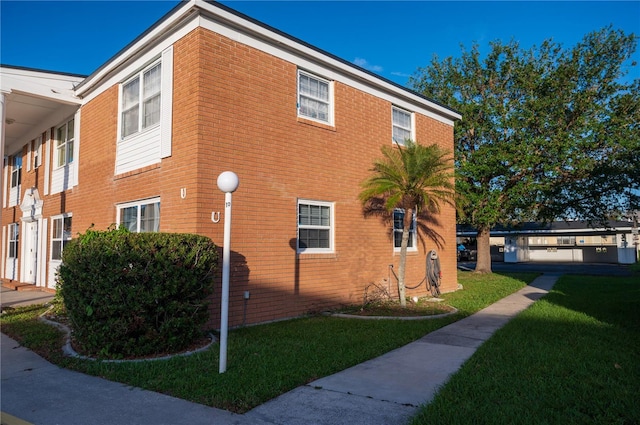 view of side of property with a lawn