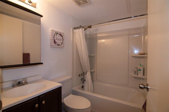 full bathroom with vanity, shower / tub combo, a textured ceiling, and toilet