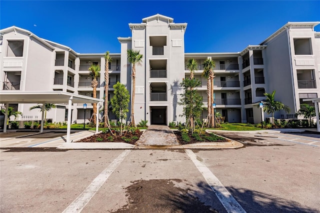 view of property featuring uncovered parking