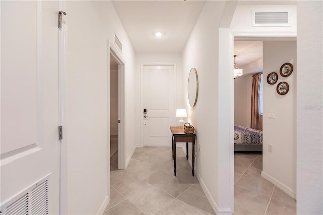 hall with light tile patterned flooring