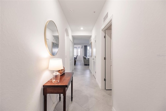 hall featuring light tile patterned floors