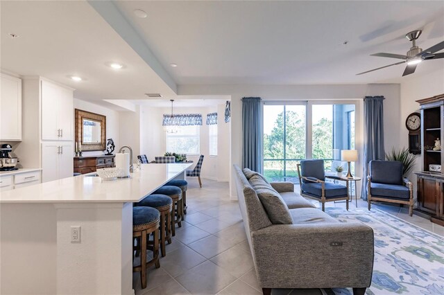 tiled living room with ceiling fan