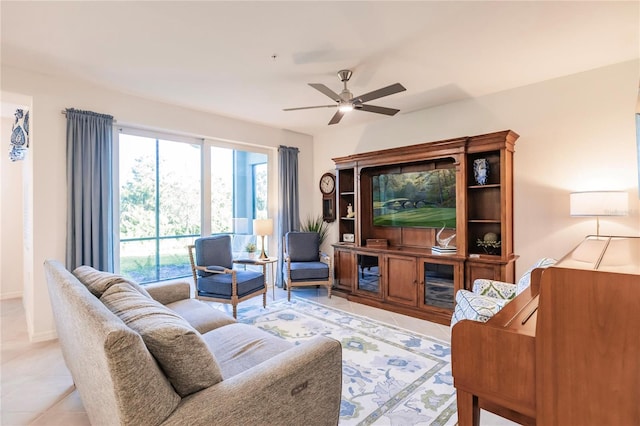 living room with ceiling fan and light tile patterned floors