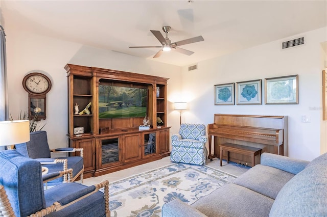 living room featuring light tile patterned floors and ceiling fan