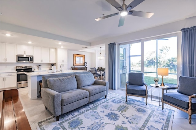 tiled living room with sink and ceiling fan