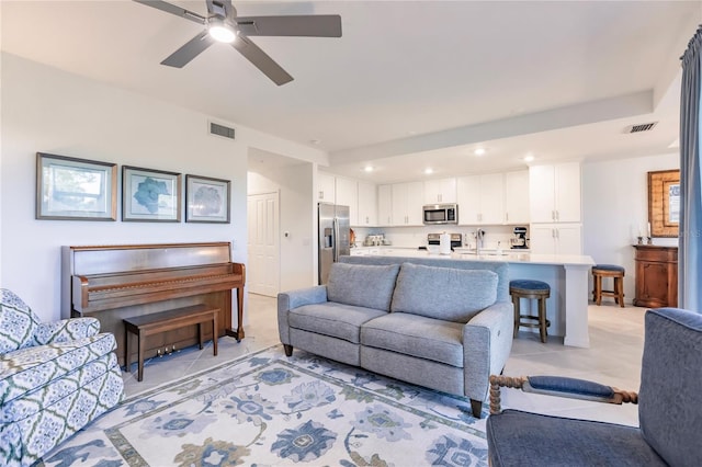 tiled living room with ceiling fan