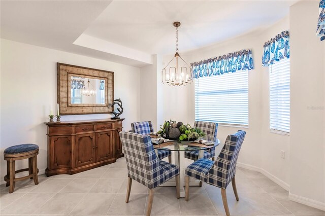 tiled dining room featuring an inviting chandelier