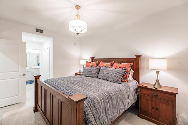 carpeted bedroom featuring ensuite bathroom