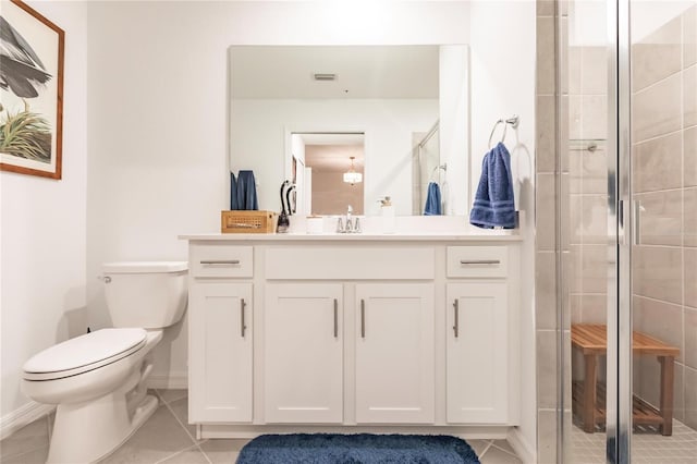 bathroom featuring toilet, vanity, walk in shower, and tile patterned floors