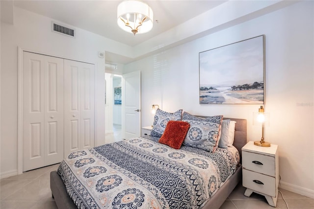 bedroom with a closet and light tile patterned floors