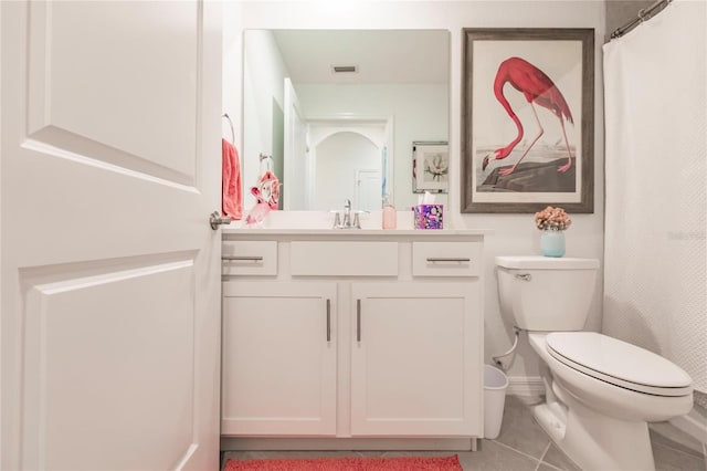 bathroom featuring toilet, vanity, and tile patterned floors