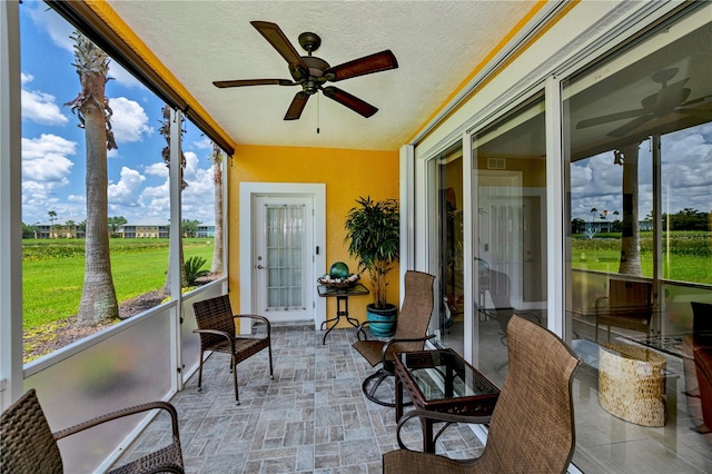 sunroom / solarium with ceiling fan and a wealth of natural light