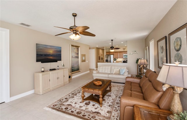 living room featuring ceiling fan and light tile patterned flooring