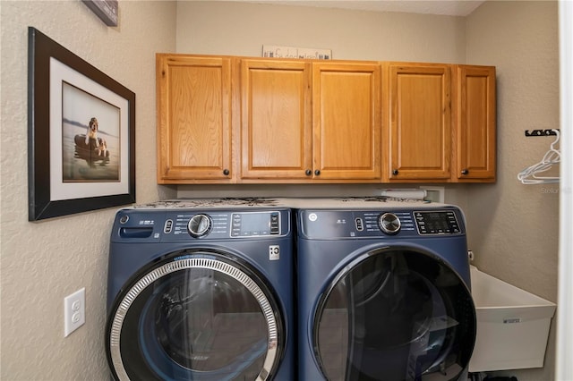 washroom with separate washer and dryer and cabinets