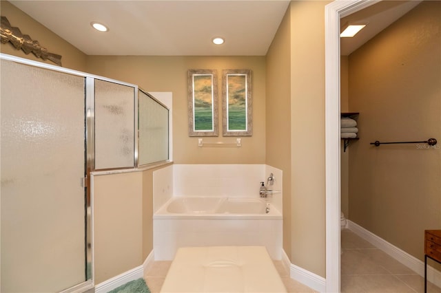 bathroom with plus walk in shower and tile patterned flooring