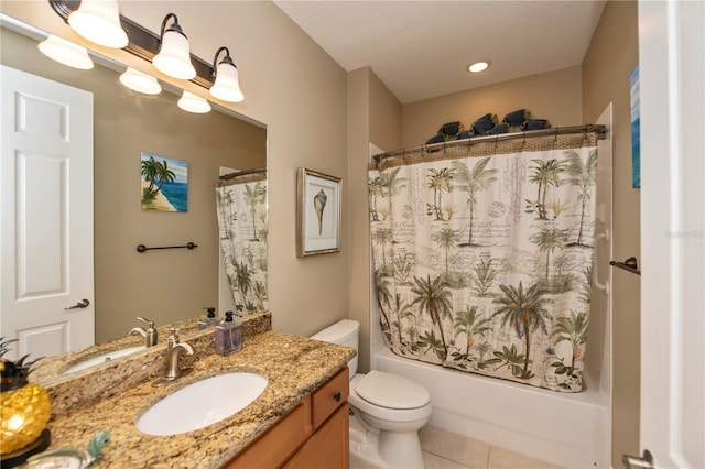 full bathroom featuring tile patterned flooring, toilet, shower / bath combo with shower curtain, and vanity